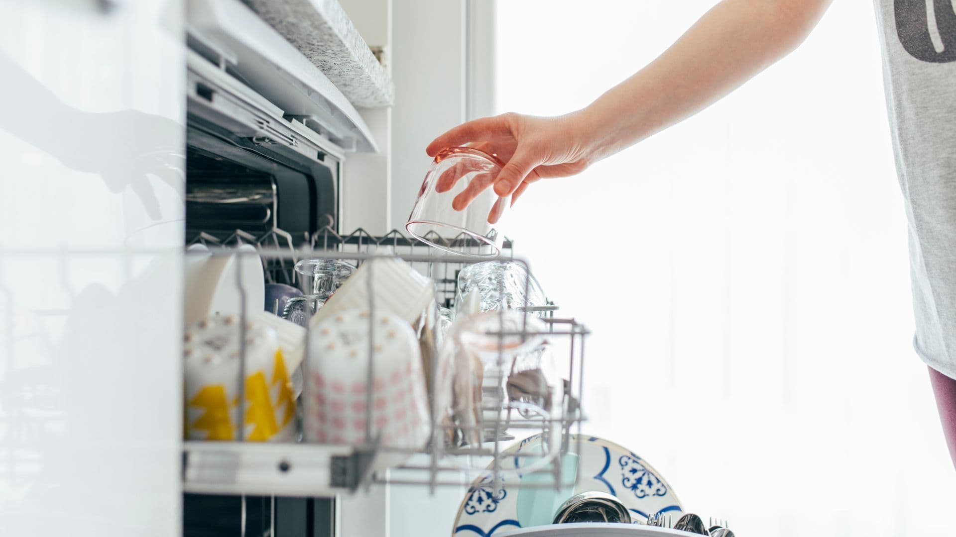 Airbnb cleaner filling the dishwasher