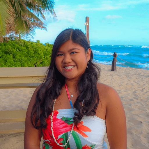 Female on the beach smiling at camera