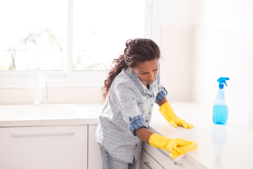 Move out cleaning service crew member cleaning kitchen countertop