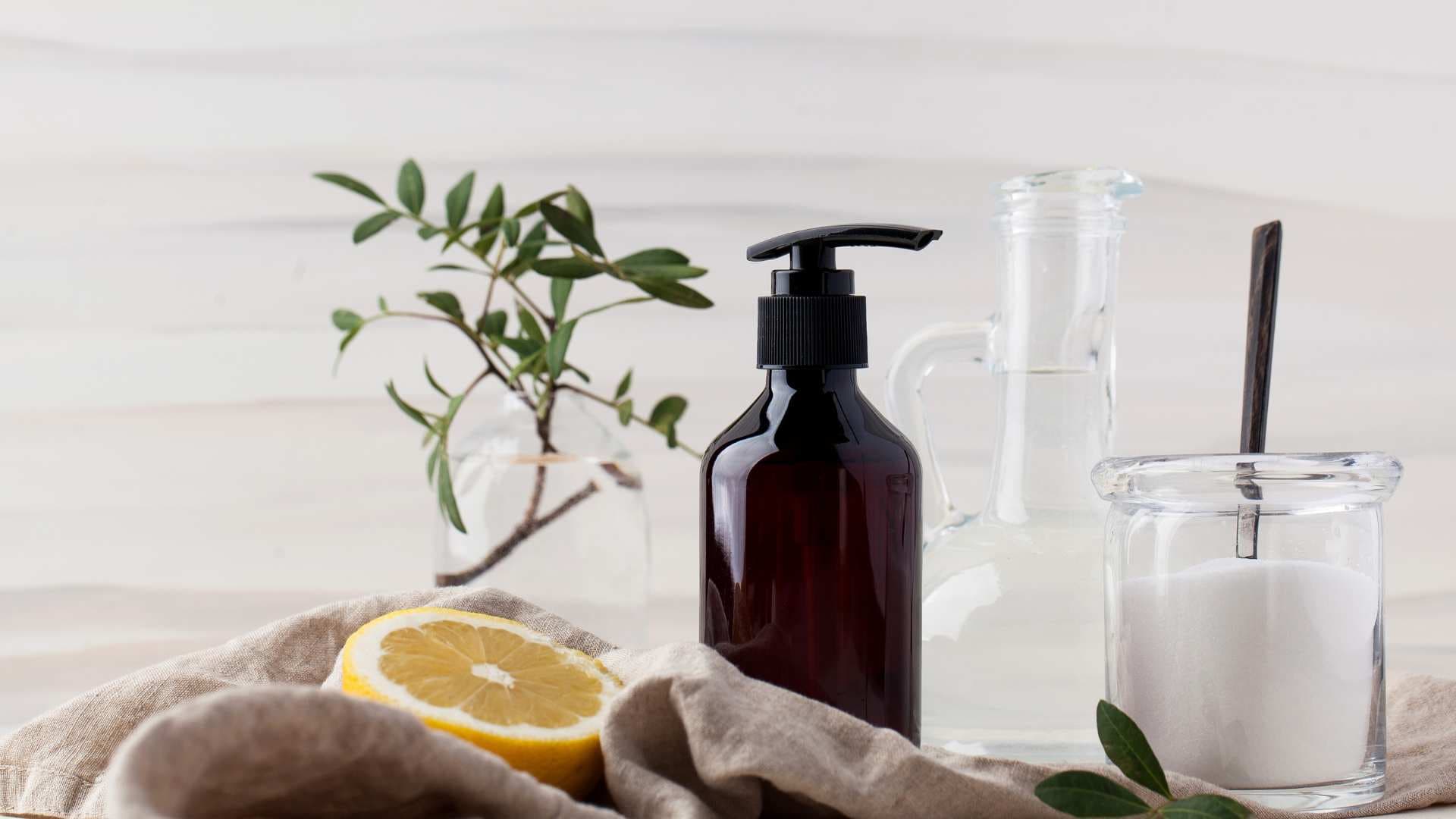 A lemon on a towel next to a brown soap dispenser bottle