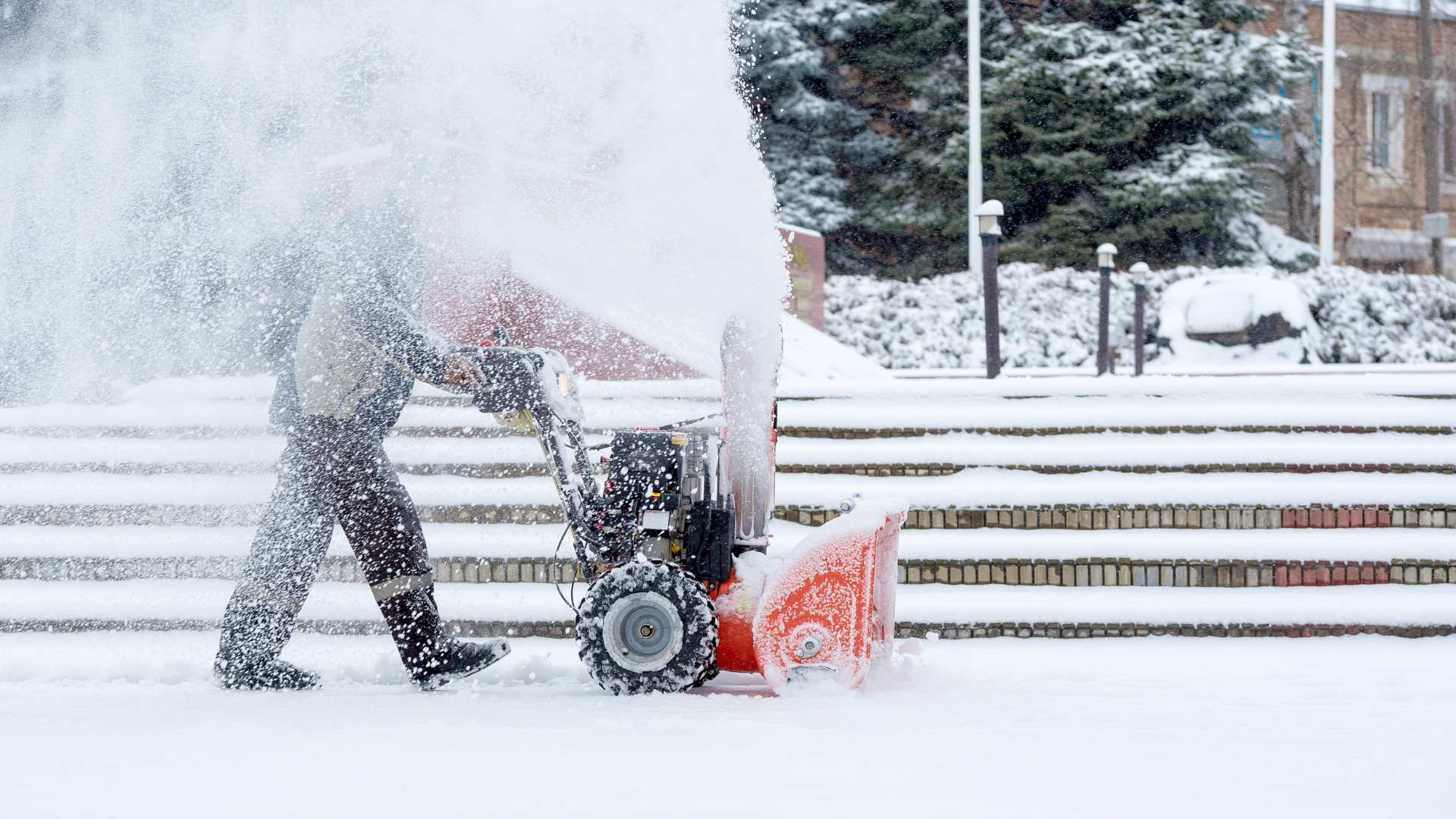 Male using a snow removal machine